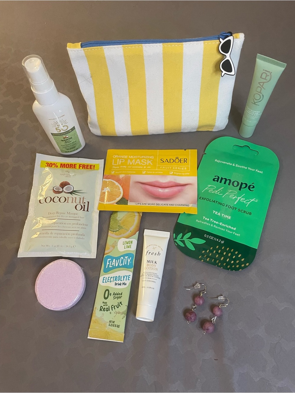 Kopari Yellow & White Striped Pouch with Skincare Essentials